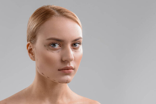Blond lady with correction lines on face