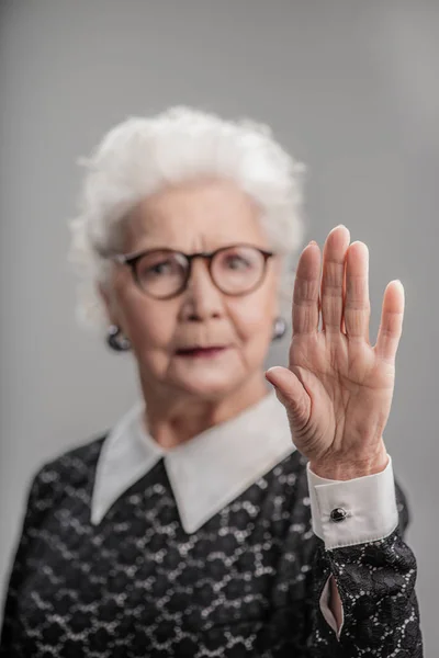 Senior female giving stop sign — Stock Photo, Image
