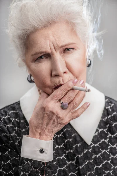Бабушка в элегантной модной одежде курение — стоковое фото