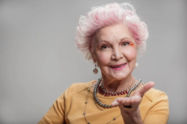 Beautiful elderly lady looking at camera — Stock Photo, Image