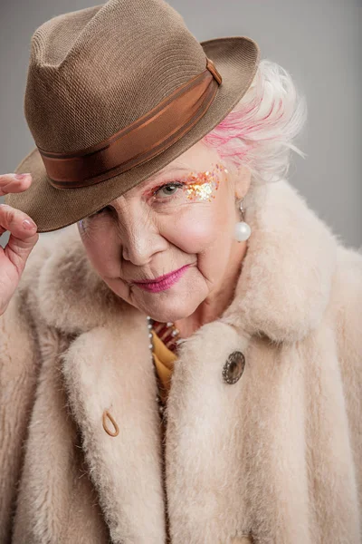 Thinking elderly female looking at camera — Stock Photo, Image