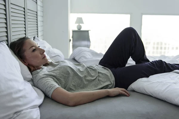 Gefrustreerd vrouw liggend op lattenbodem — Stockfoto