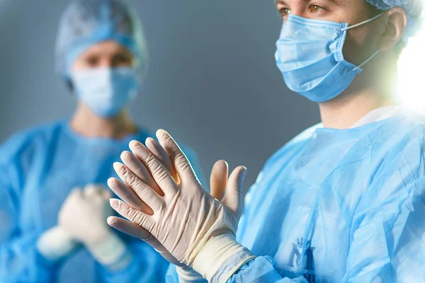 Concentrated doctors dressed in surgical uniform — Stock Photo, Image