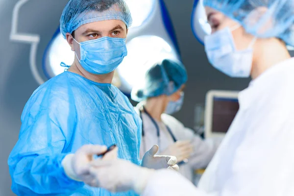 Attentive doctor holding medical tool — Stock Photo, Image