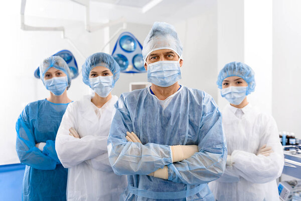 Serious doctors in operating theatre