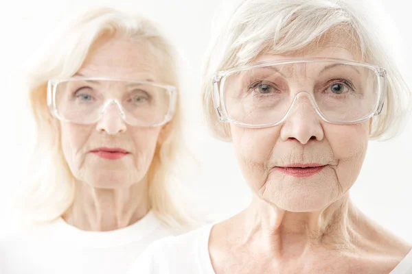 Confident senior ladies taking care of eyesight — Stock Photo, Image