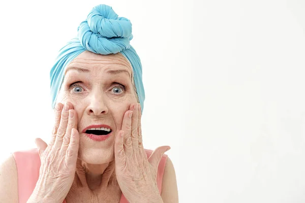 Old woman is surprised by her wrinkles — Stock Photo, Image