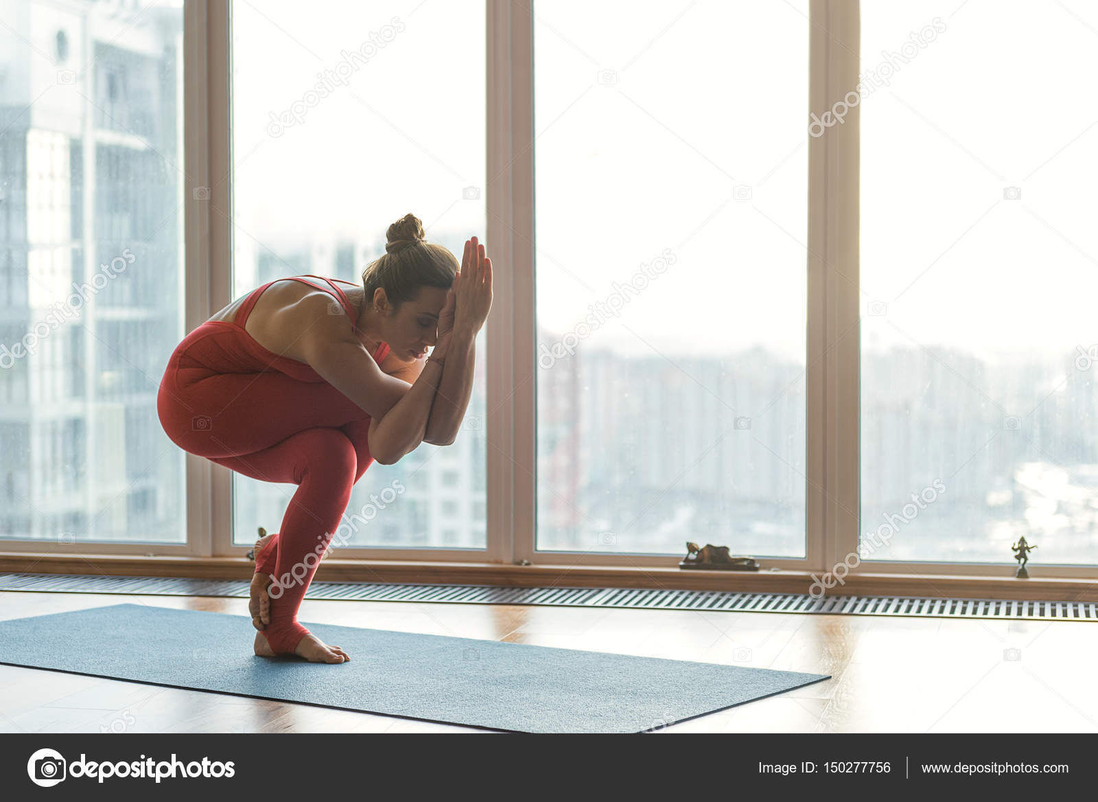 Professional female yogi standing in strange position — Stock Photo