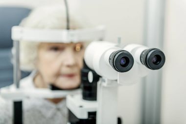 Yaşlı optik cihazı yakın yerlerde oturan kadın