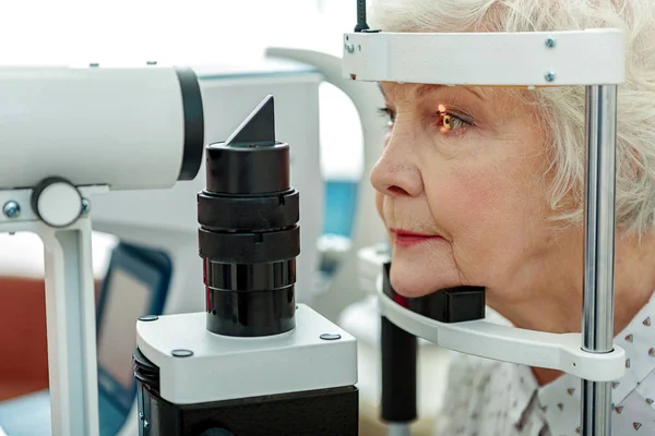 Sight of old woman verifying by apparatus — Stock Photo, Image