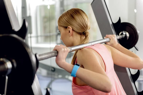 Careful athlete squatting with barbell in gym — Stock Photo, Image