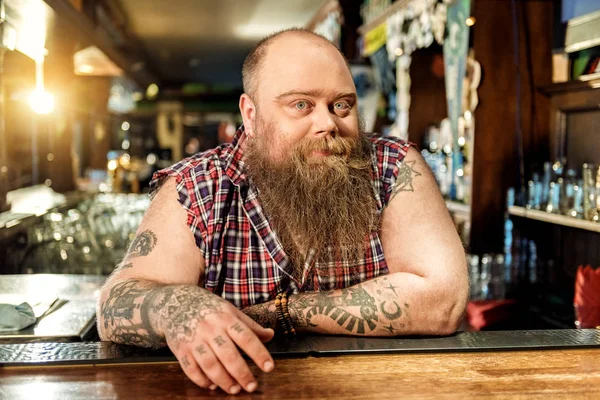 Thoughtful bearded man expecting clients in pub — Stock Photo, Image