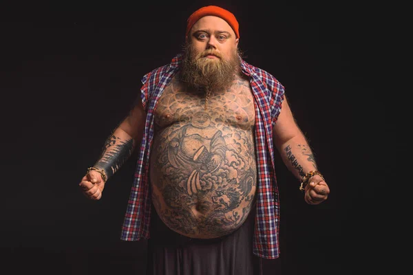 Premium Photo  Overweight man with big belly and tattoos in sports wear is  holding his stomach with shocked emotion
