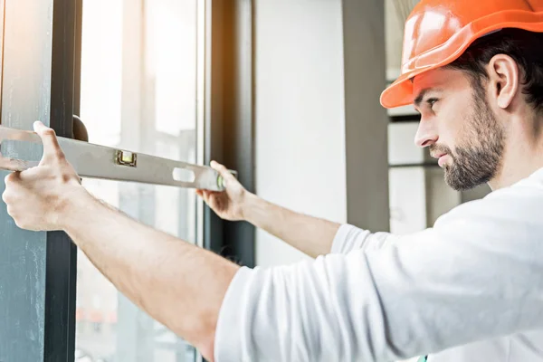 Serious male contractor using tool — Stock Photo, Image