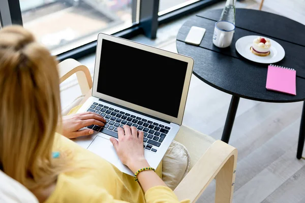 Elegant young lady sitting in chair with notebook and working — Stock Photo, Image