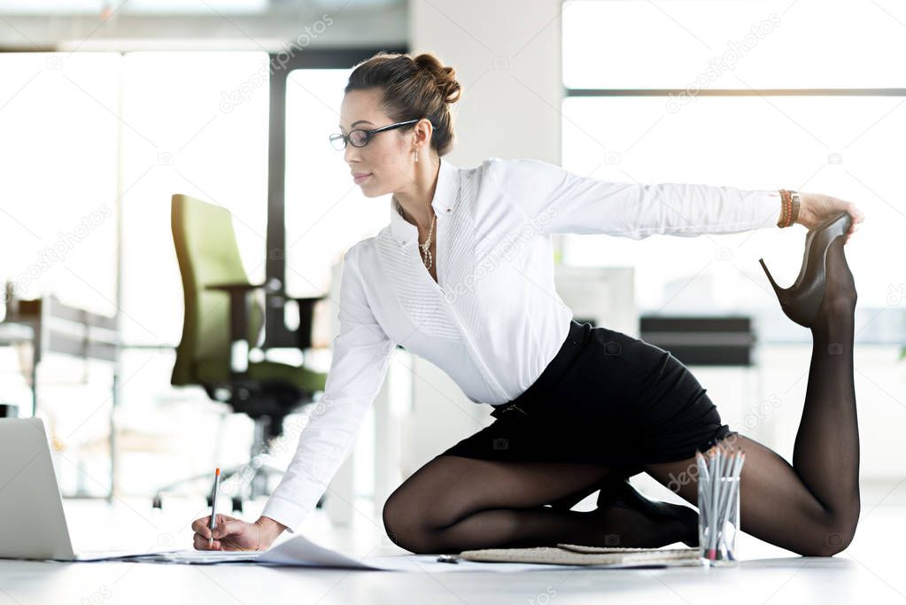 Flexible female working on table at office