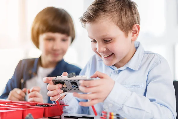 Happy smiling young technician keeping toy — Stock Photo, Image