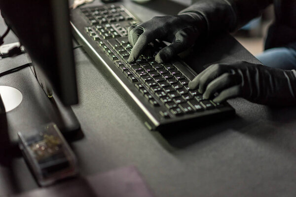 Hacker arms typing on keyboard