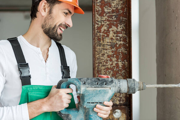 Happy smiling foreman keeping drill