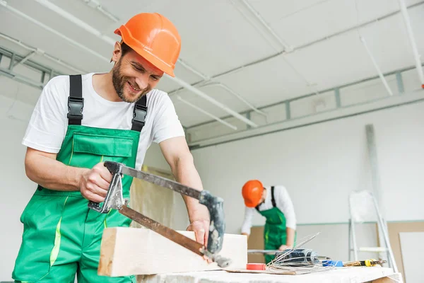 Glücklich lächelnde Bauarbeiter beim Wiederaufbau — Stockfoto