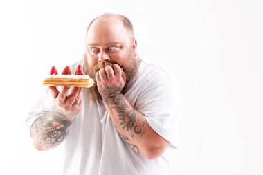 Starving fat man staring at mouthwatering dessert clipart