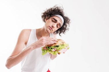 Skinny guy is seduced by unhealthy food clipart