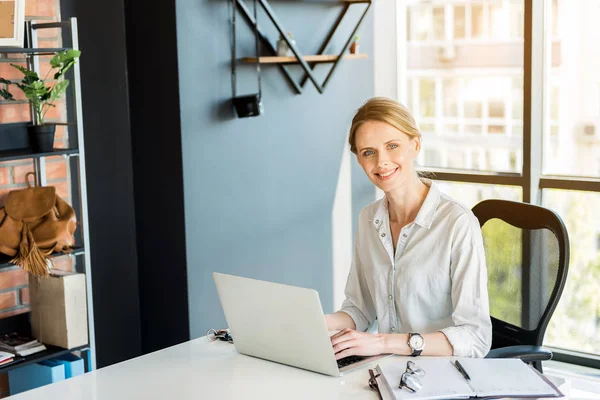 Professional attractive employee working in office cheerfully — Stock Photo, Image