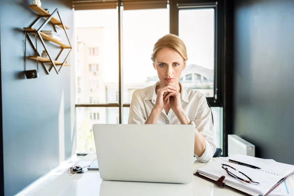 Attractive serious woman working in office pensively — Stock Photo, Image