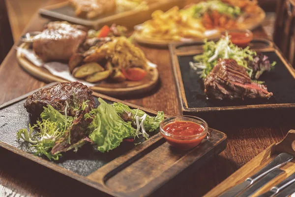 Delicious tasty food on wooden table — Stock Photo, Image