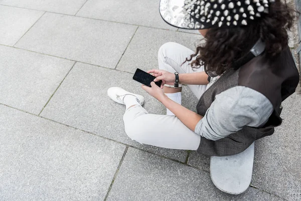 Adolescente na moda está lendo mensagem no celular — Fotografia de Stock