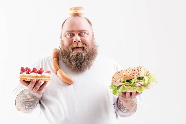 Vrolijke dikke man geeft de voorkeur aan ongezond eten — Stockfoto