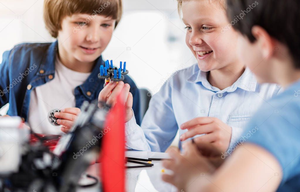 Happy smiling young technicians making toy
