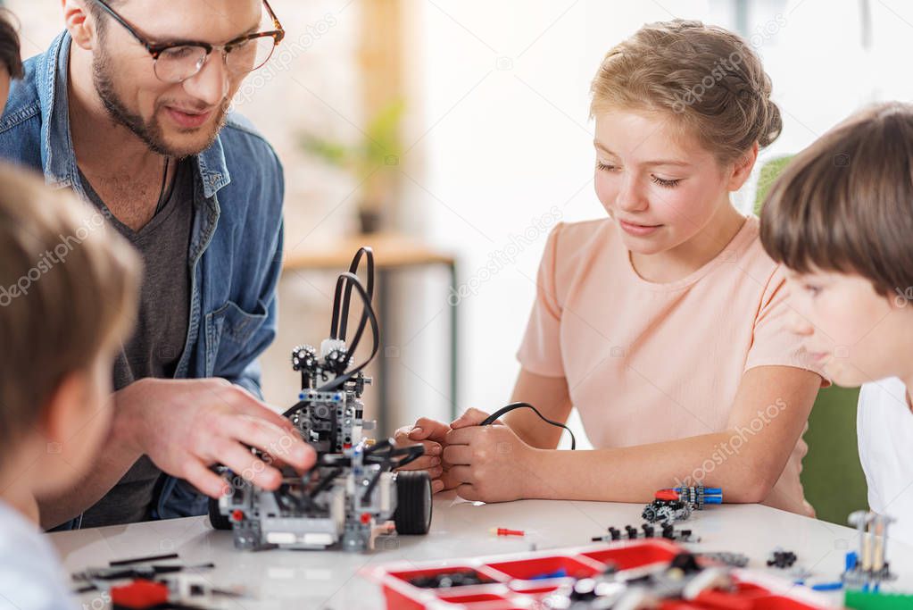 Interested young technicians creating toy