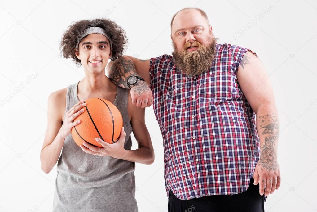 Joyful fat hipster and thin outcast are friends