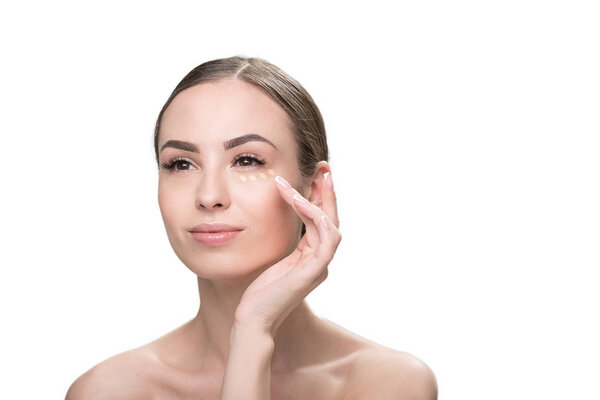 Cheery attractive girl using decorative facial make-up