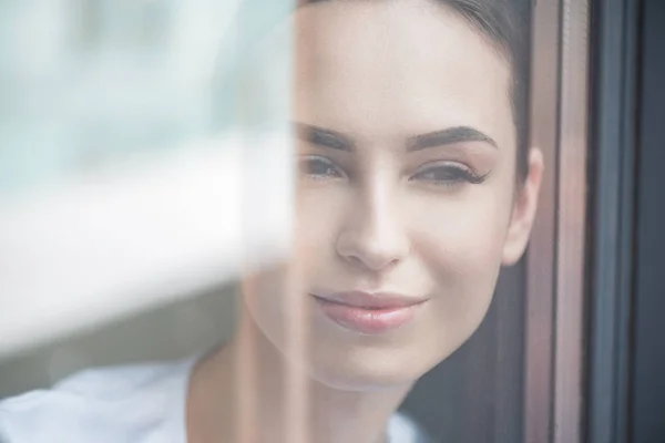 Happy youthful lady watching on street from her apartment — Stock Photo, Image