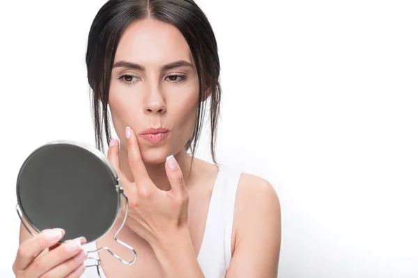 Menina séria olhando para o seu rosto reflexão — Fotografia de Stock