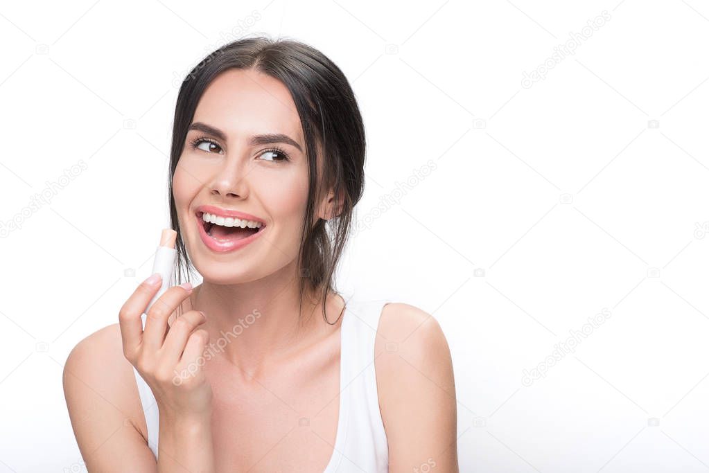 Happy girl doing make-up by lipstick