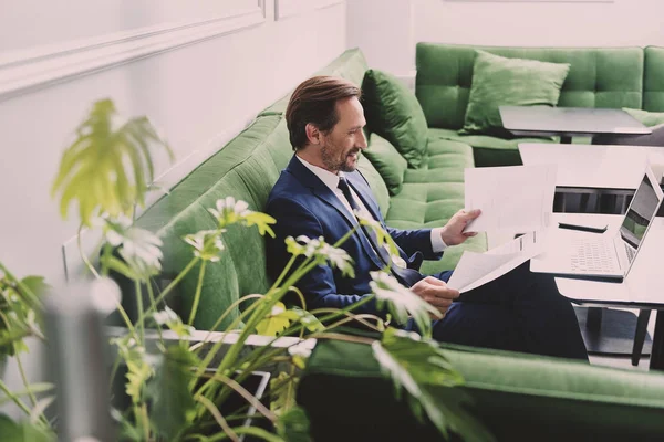 Successful male manager looking through official papers — Stock Photo, Image