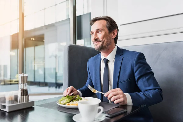 Happy businessman dreaming during dinner — Stock Photo, Image
