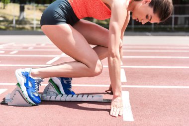 Başlama pozisyonu, kendine güvenen kadın sprinter ayakta