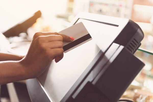 African cashier female is paying for order