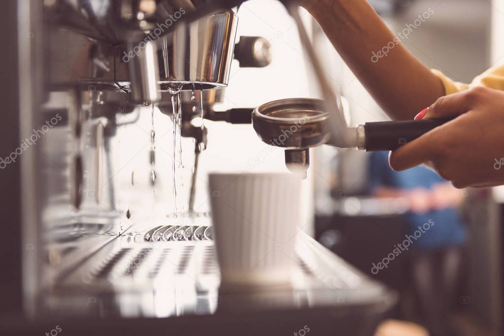 Girl barista is preparing fresh cappuccino