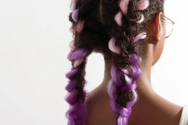 Cute mulatto female is demonstrating violet pigtails — Stock Photo, Image