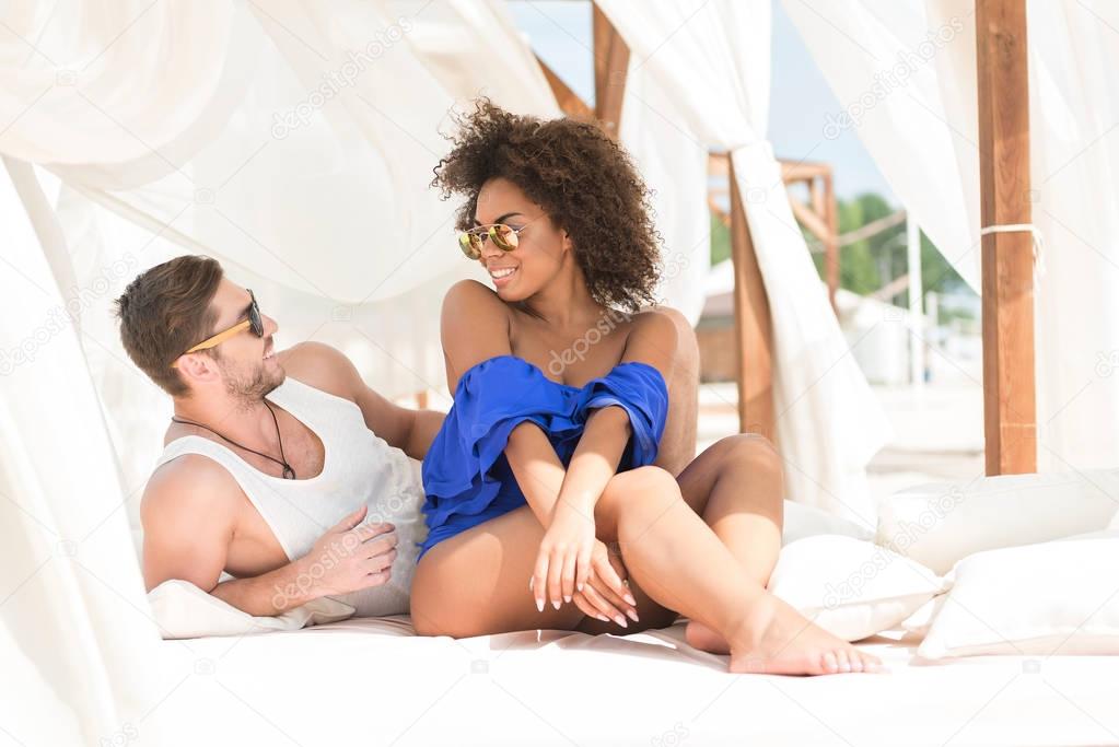 Happy youthful couple resting on summer resort