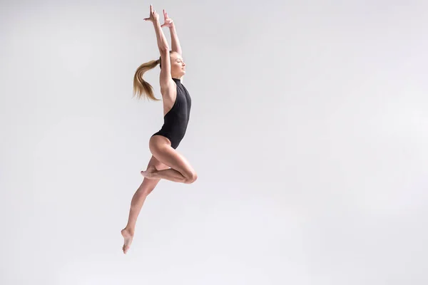 Cheerful young female athlete practicing some exercises — Stock Photo, Image