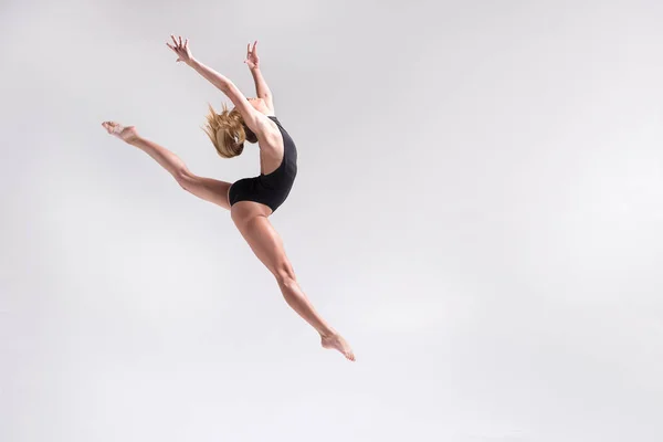 Chica joven pensativa haciendo gimnasia salto — Foto de Stock