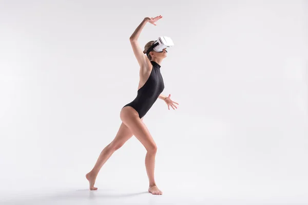 Somber youthful woman simulating dance from goggles — Stock Photo, Image