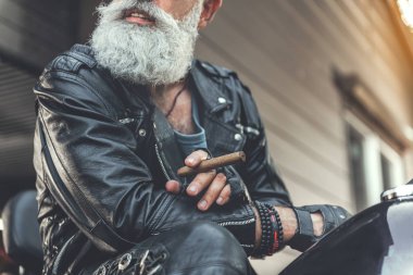 Yaşlı erkek kişi motosiklet üzerinde gülümseyen