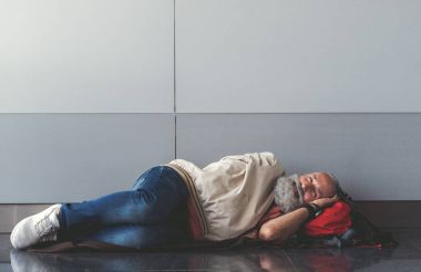 Happy smiling old man lying on floor clipart